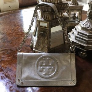 Tory Burch leather clutch with a removable strap.